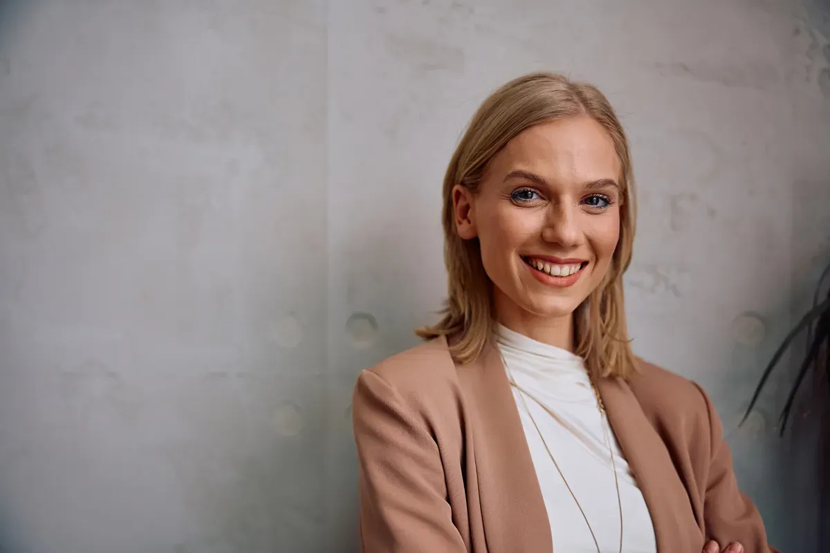 A smiling credit union employee talking with a colleague