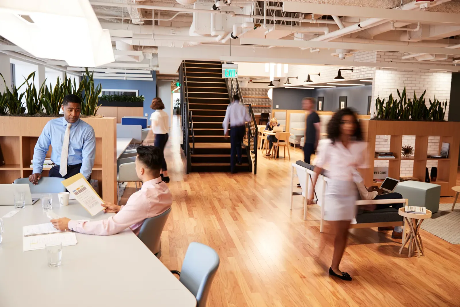 Credit union employees collaborating in a bright open office